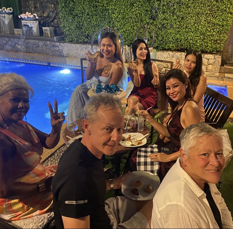 Guests celebrating a poolside evening at Shrubsole House